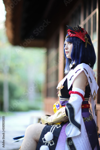 Japanese young woman hunter cosplay with bow on Japanese garden