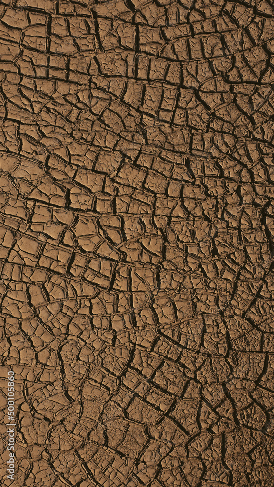 Brown dry sand cracks textures in the desert. Brown dry sand cracks textures in the desert.