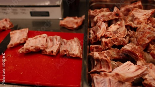 Professional chef in the kitchen of a restaurant. A male chef in a black uniform is working in the kitchen. Slow motion 4K