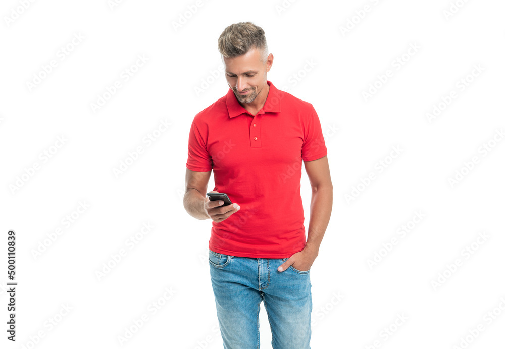 man in red tshirt messaging on smartphone isolated on white background man in red tshirt messaging on smartphone isolated on white background