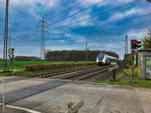  Train on a railway crossing close to the village of Hauenhorst on its way from Munster to Rheine railway station photo