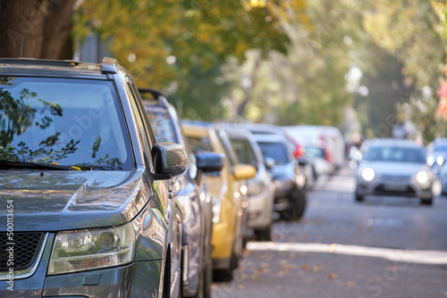 City traffic with many cars parked in line on street side