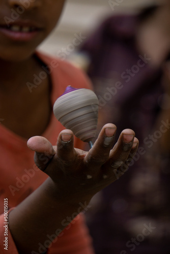 21 march 2022, Dhaka, Bangladesh. A child is swinging a latim on his hand. photo