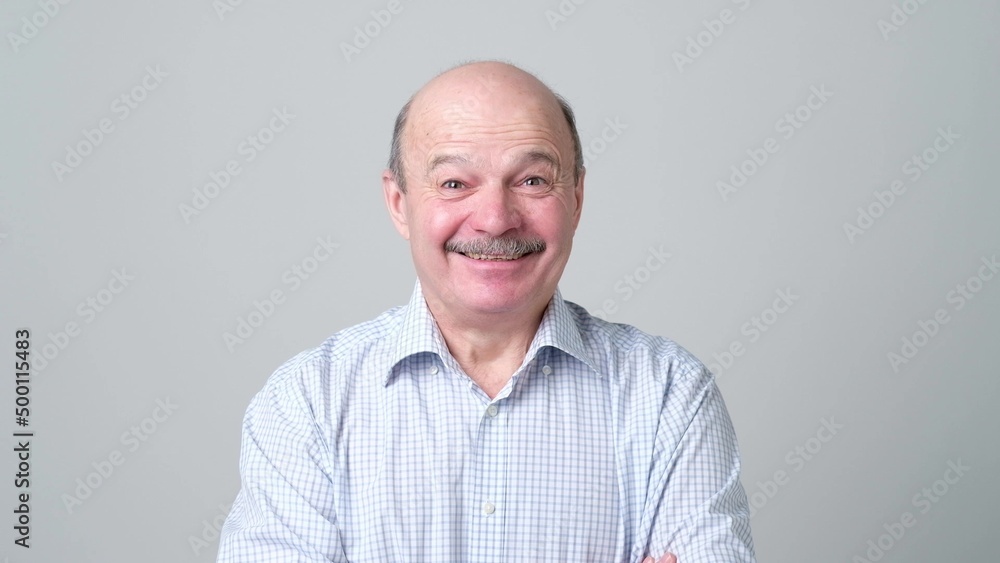 Mature adult man laughing looking at the camera. Positive emotion concept Mature adult man laughing looking at the camera. Positive emotion concept