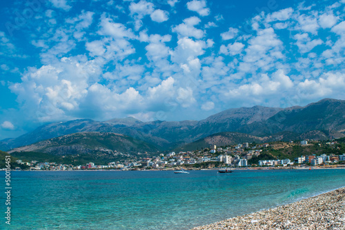 Beautiful summer cloud landscape of beach town of Himare. Adriatic sea. Albania. Concept of summer holidays and relaxation.