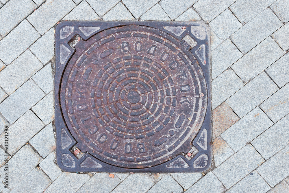 Old manhole cover in the street