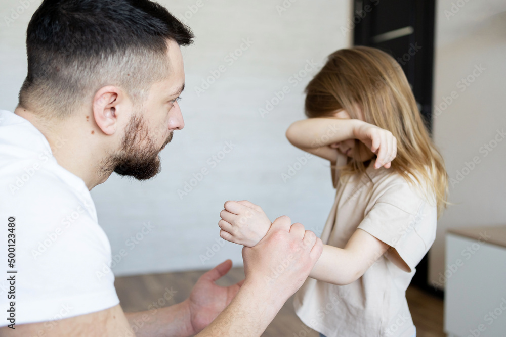 The concept of violence and abuse in the family. Father punishing his child. The concept of violence and abuse in the family. Father punishing his child.