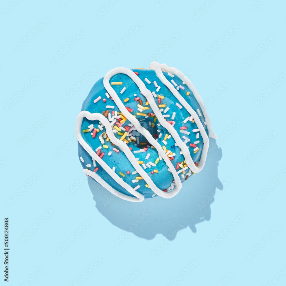 blue donut with glaze on blue pastel background blue donut with glaze on blue pastel background