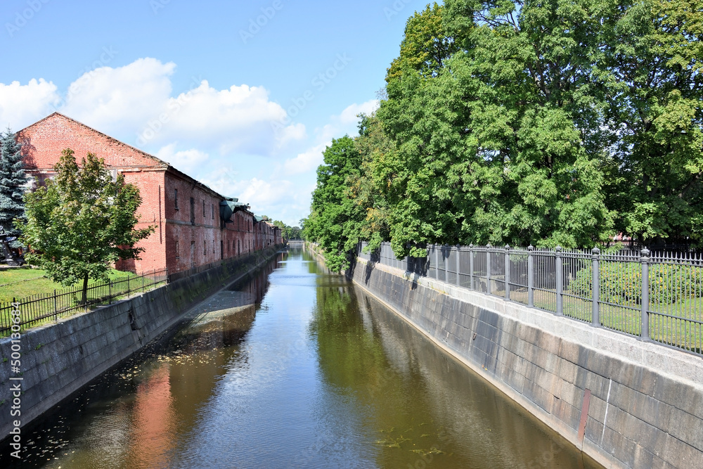 Kronstadt canal with old building and blue sky background Kronstadt canal with old building and blue sky background