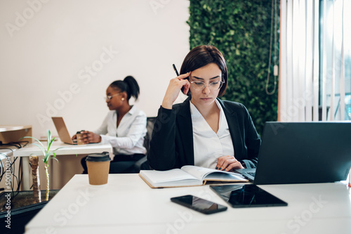Business working on a laptop in a creative office environment