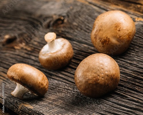 Mushrooms on a old wooden table, selective focus, space for text, stock photo