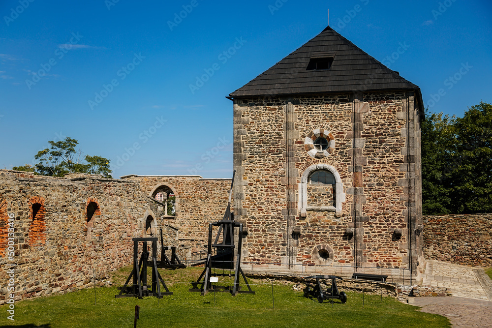 Cheb, Western Bohemia, Czech Republic, 14 August 2021: Gothic stone castle, medieval historic fortress or stronghold in sunny summer day, black Tower, ballista wooden siege weapons near defense walls