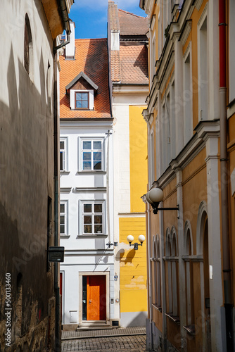 Cheb  Western Bohemia  Czech Republic  14 August 2021  narrow picturesque street with medieval colorful gothic merchant houses  Eger at sunny summer day  historic renaissance and baroque buildings