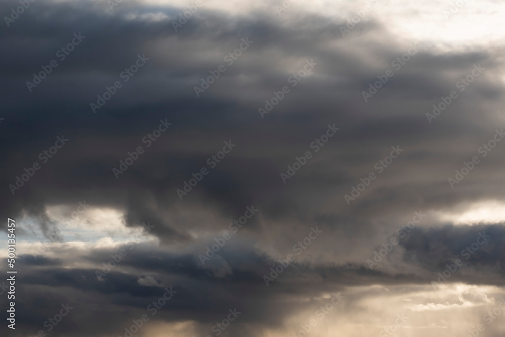 Dark and dramatic clouds in a sky. Abstract background for design purpose and sky replacement.