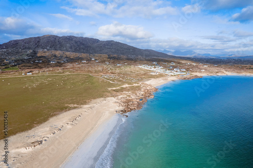 Beautiful Gurteen bay beach and blue color ocean water, cloudy sky. Stunning Irish nature scene in county Galway, Ireland. Warm sunny day. Popular travel area with stunning scenery
