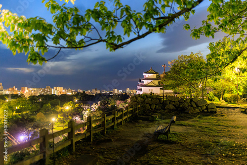 Bench at viewpoint overlooking historic Japanese castle and downtown Akashi 