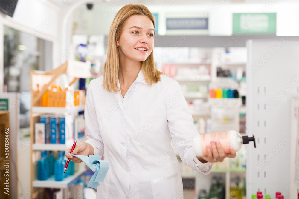 Portrait of friendly laughing pharmacist working in modern farmacy. High quality photo