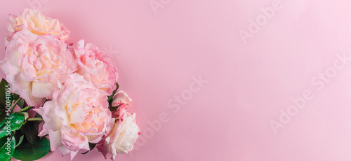 Fototapeta Naklejka Na Ścianę i Meble -  Pink rose flower on pastel pink background. Top view with copy space.