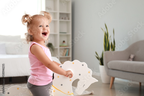Adorable baby girl with roc...