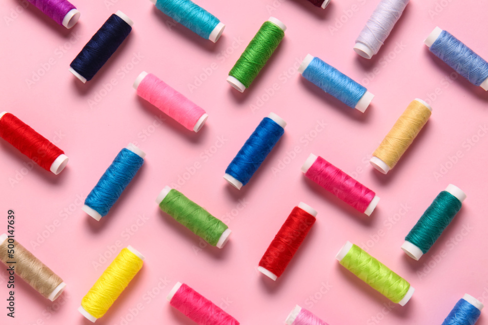 Thread spools on pink background Thread spools on pink background