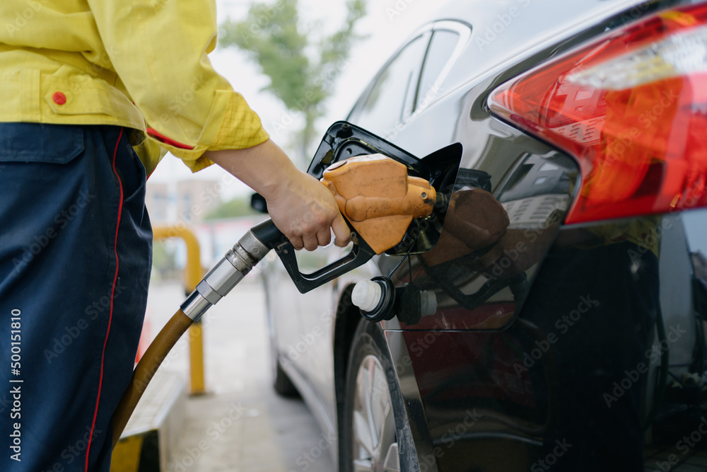 The car is filling up at the gas station
