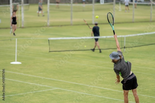 Amateur playing tennis at a tournament and match on grass in Melbourne, Australia 
