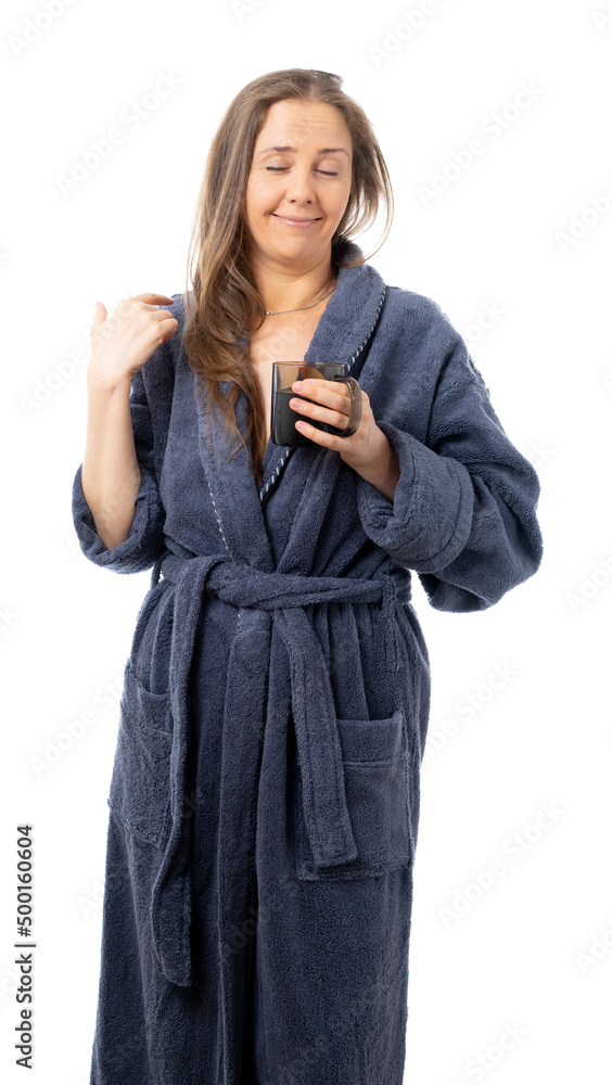 A woman in a bathrobe holds a mug of water and speaks on the phone. the duffler drinks a lot of water. communicate with close people at a distance. isolated. A woman in a bathrobe holds a mug of water and speaks on the phone. the duffler drinks a lot of water. communicate with close people at a distance. isolated.