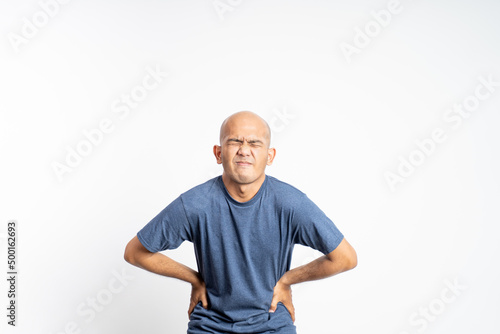 asian bald man having stomach ache feeling twisted on isolated background