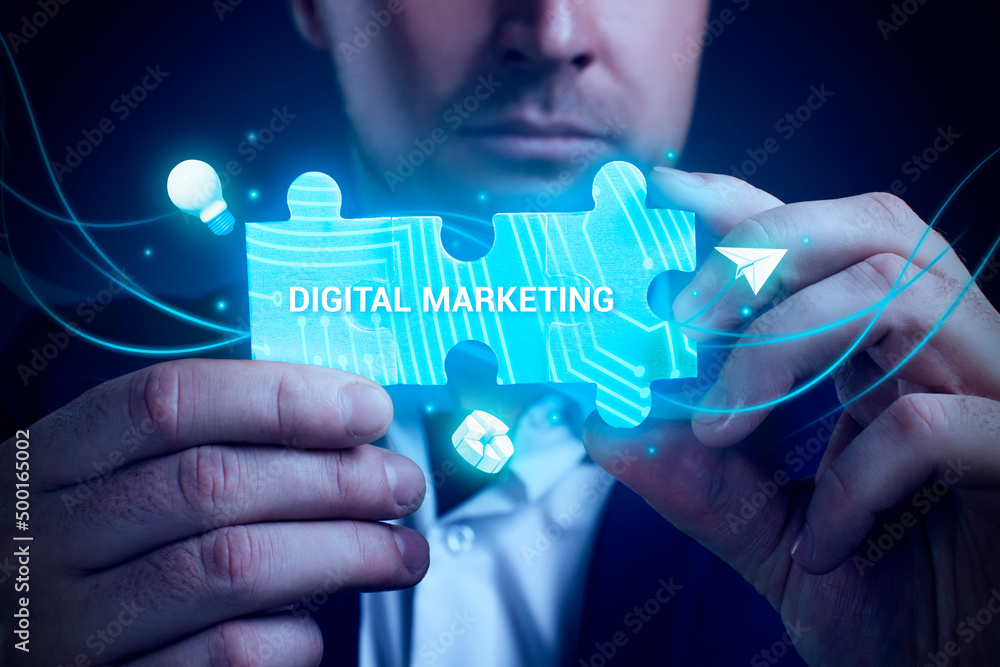 Obraz premium Business, Technology, Internet and network concept. Young businessman working on a virtual screen of the future and sees the inscription: Digital marketing