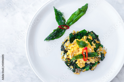 Thai Food Stir-fried Malindjo Leaves with Egg photo