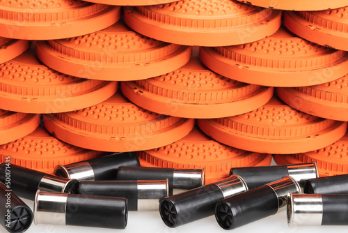 Stack of flying clay pigeon targets and shotgun shell bullets on white background , Gun shooting game