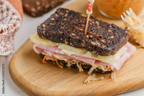 Spicy Reubens. A delicious homemade sandwich made of rye bread, sauerkraut, meat, cheese and mayonnaise. Pastrami Reuben style sandwich. Selective focus