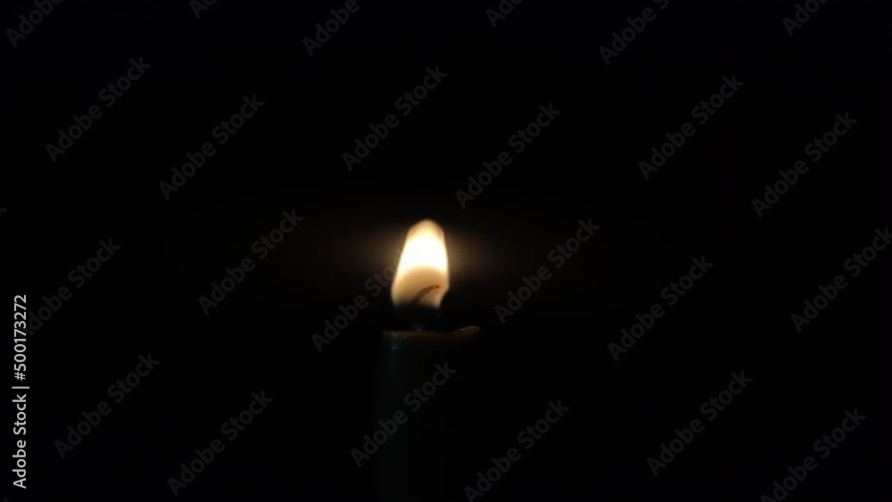 Candle burns on a black background. Vertical video. Candle burns on a black background. Vertical video.