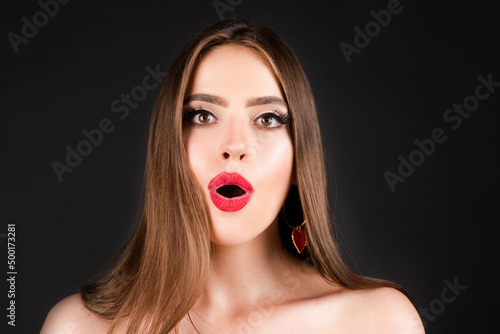 Shocked face of surprised young woman. Funny female shocked face expression. Unbelievable. Portrait of excited woman spreading hands. Expressing surprise open mouth. Emotional face.