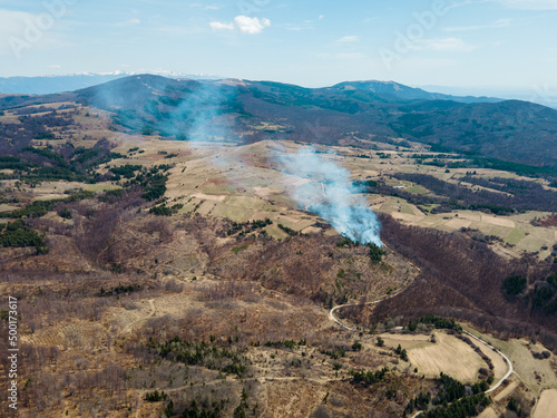 Aerial view of smoke from fire in the mountain during spring