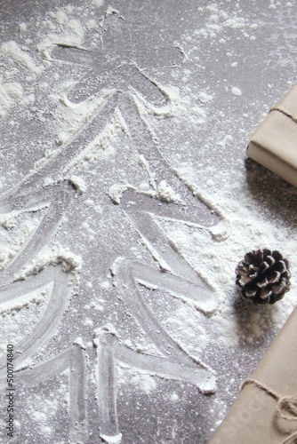 Draw a Christmas tree on the dough and presents made from recycled paper.