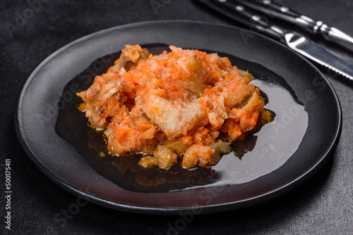 A delicious dish of hake fish in chunks in tomato sauce with spices and herbs