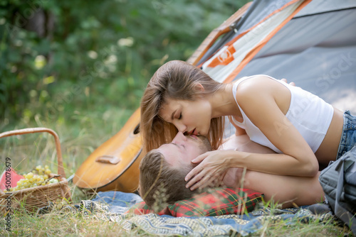 Romantic couple kissing on an camp. Kissing lovers. Picnic couples. photo
