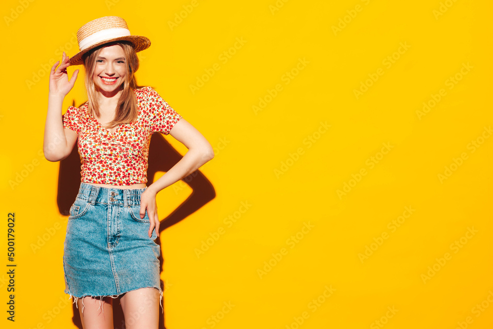 Portrait of young beautiful smiling blond female in trendy summer clothes. carefree woman posing near yellow wall in studio. Positive model having fun indoors. Cheerful and happy. In hat Portrait of young beautiful smiling blond female in trendy summer clothes. carefree woman posing near yellow wall in studio. Positive model having fun indoors. Cheerful and happy. In hat
