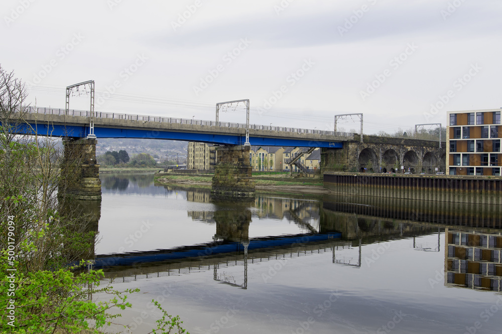 Symmetrical reflections of the Carlisle Bridge, in the River Lune.