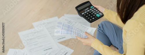 Obraz na plátně Top view owe asian woman, female sitting on floor stressed and confused by calculate expense from invoice or bill, have no money to pay, mortgage or loan