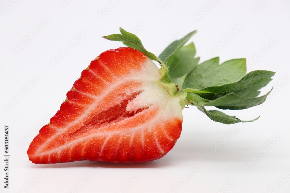 sliced strawberry with leaf on white background sliced strawberry with leaf on white background