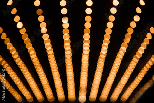 Rows of illuminated globes under the marquee as often used at entrance to theatres and casinos