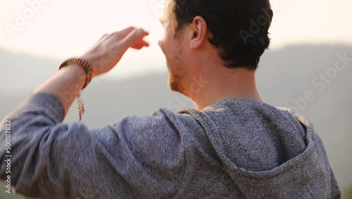 Caucasian male take a photo with his phone while hiking outdoors