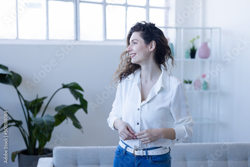 Portrait of young woman in modern apartment side view