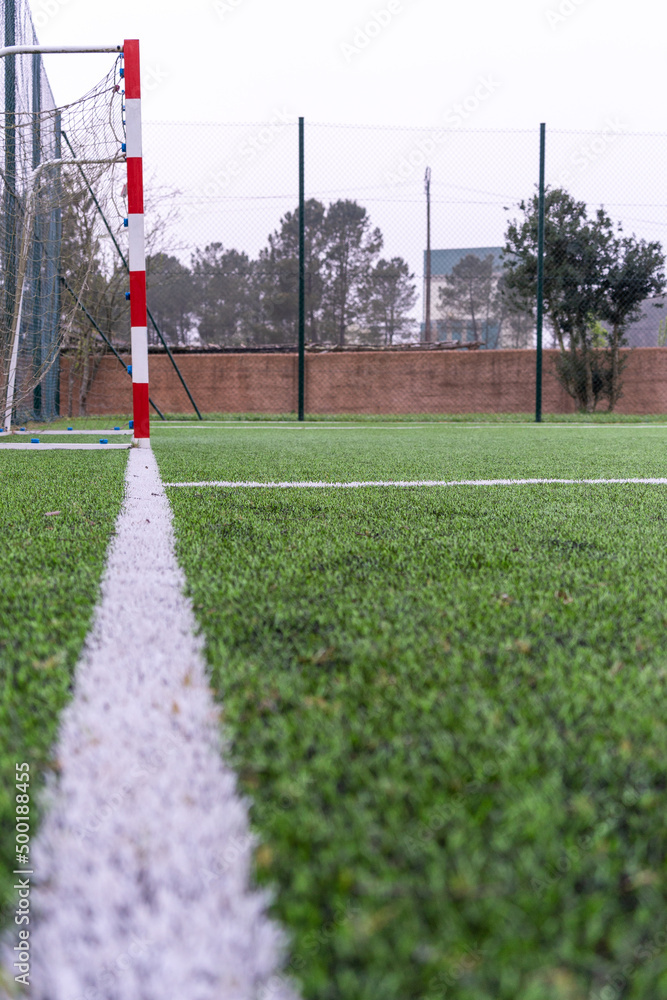 Close up of white line from the corner of a soccer field pointing towards the goal. Soccer concept. Vertical shot. . High quality photo
