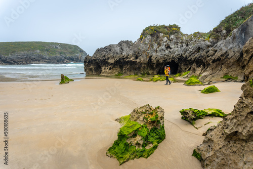 A mother with her son at the Playa de Sorraos on the Borizu peninsula in the town of Llanes. Asturias. Spain photo