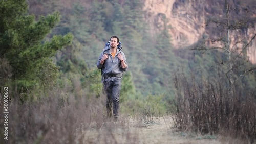 Young man hikes in nature