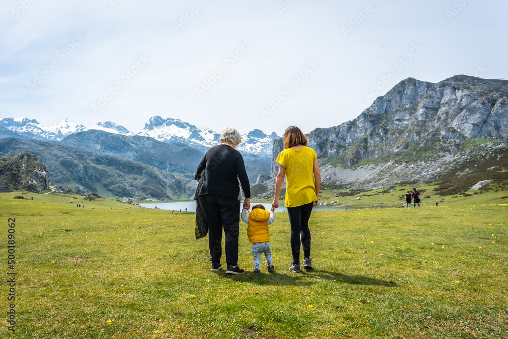 Three generations visiting Lake Ercina in the Lakes of Covadonga. Asturias. Spain