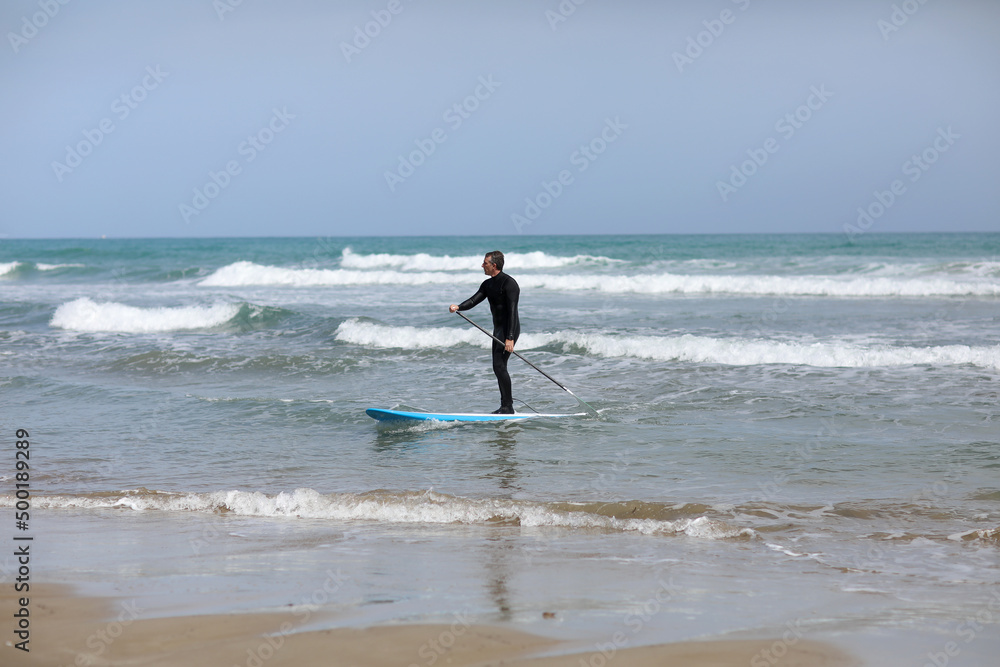Stand up paddle boarding. Young man floating on a SUP board. The adventure of the sea with blue water on a surfing. Stand up paddle boarding. Young man floating on a SUP board. The adventure of the sea with blue water on a surfing.
